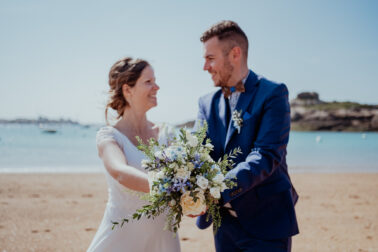 couple se regardant bouquet de fleurs plage mer